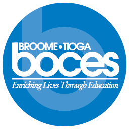 The image showcases a logo set against a blue circle backdrop. Inside, "Broome-Tioga BOCES" is elegantly written in white text, accompanied by the phrase "Enriching Lives Through Education," symbolizing our commitment as partners in educational excellence.